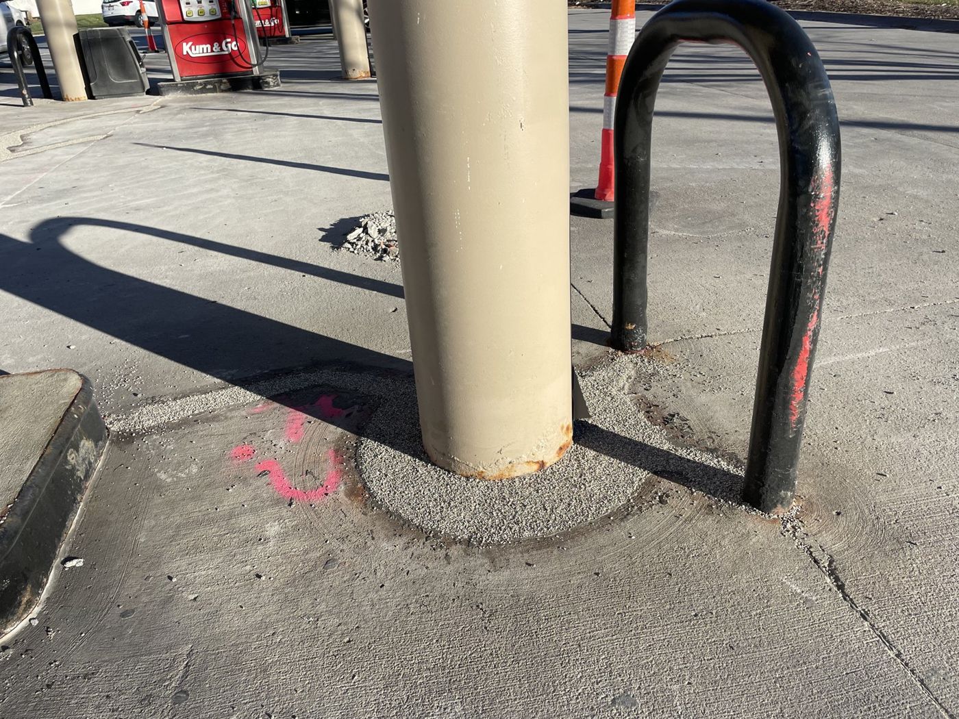 Sealed bollard base and surrounding concrete at an Omaha-area fuel station