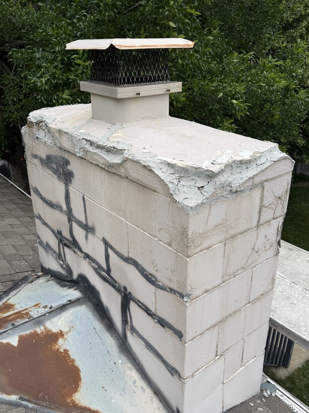Chimney masonry showing cracked joints before repair in Omaha, NE
