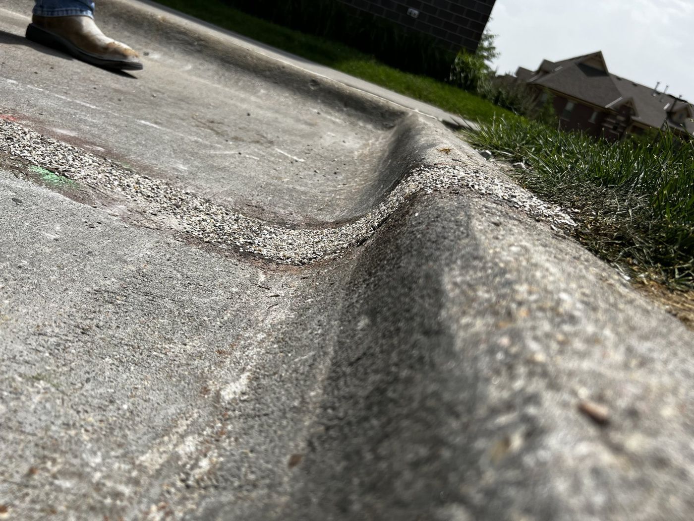 Close-up of a repaired concrete curb and gutter in the Omaha area