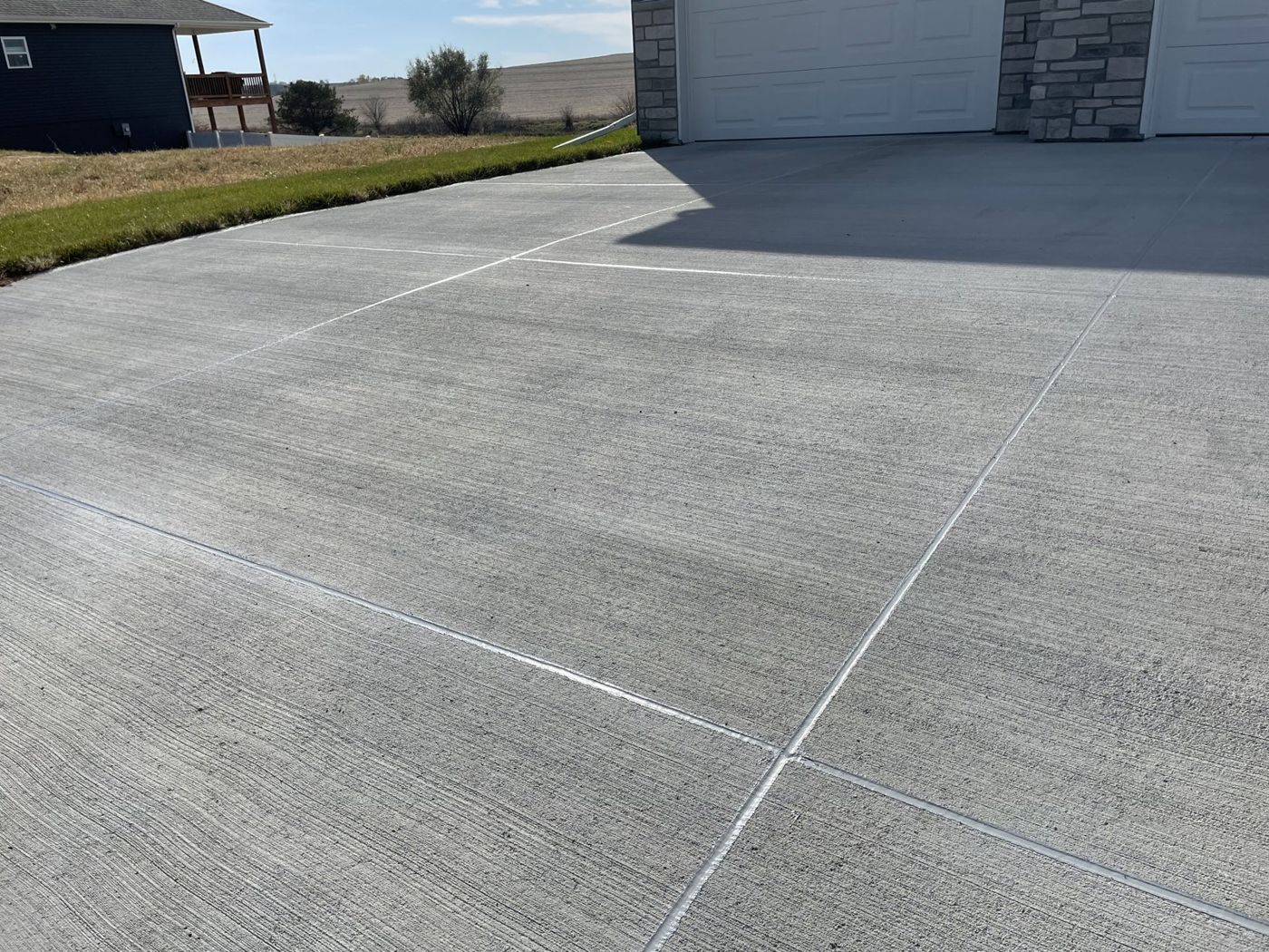 Finished concrete driveway with clean control joints at an Omaha-area home