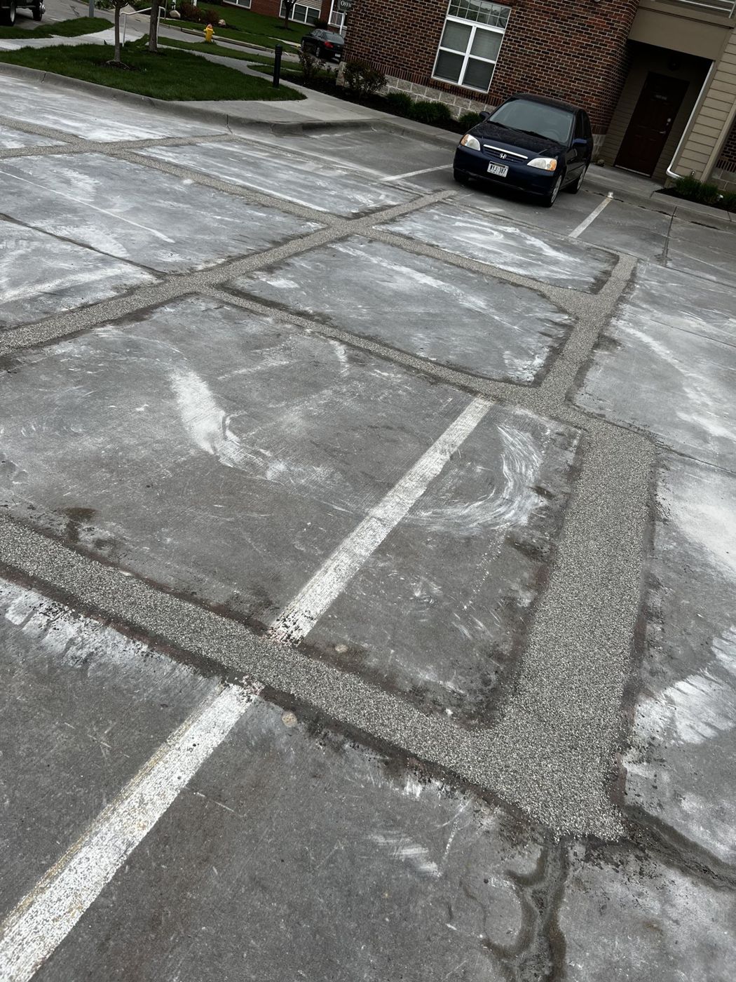 Deteriorated parking lot concrete prepared for restoration in Omaha, NE