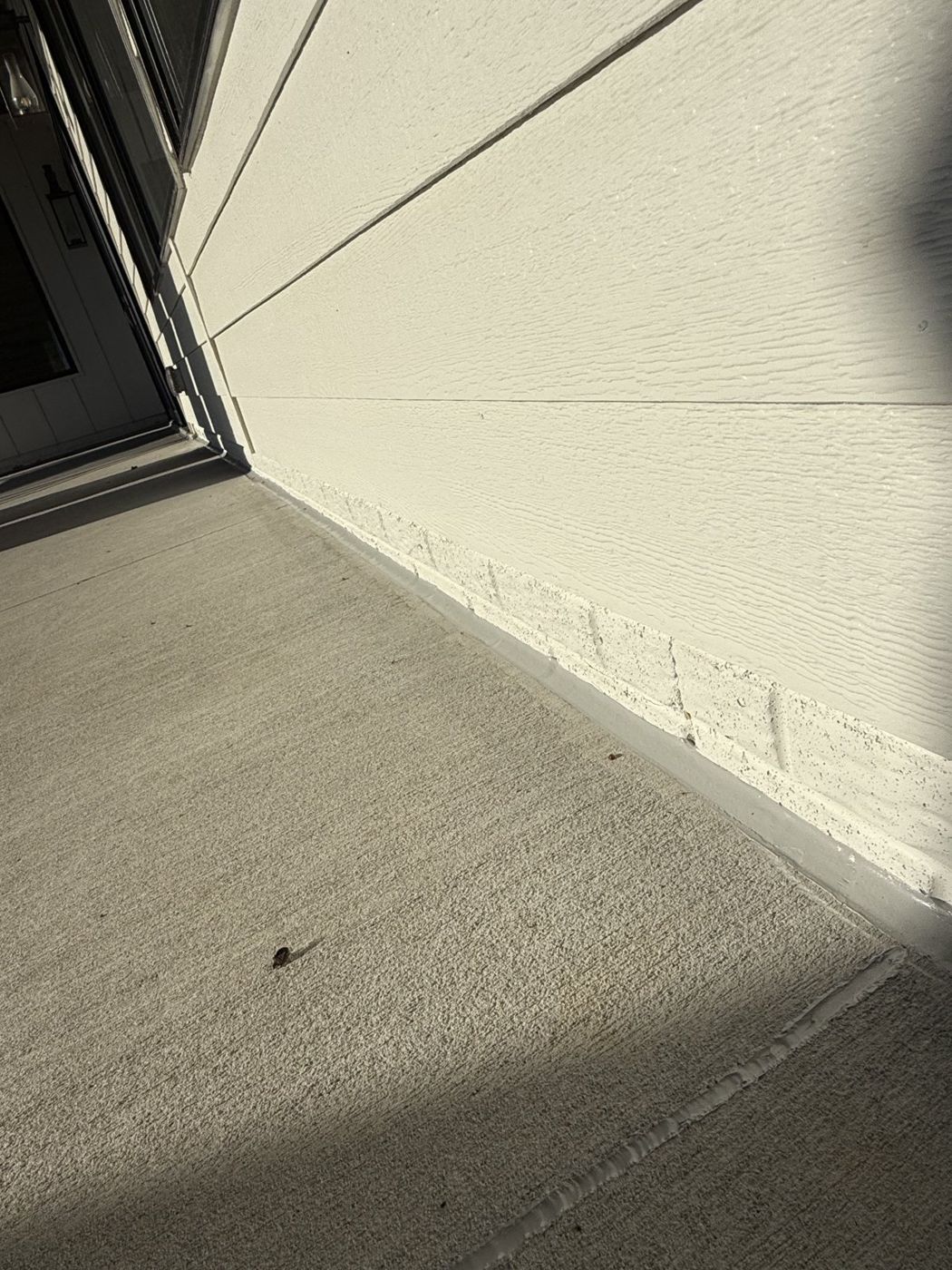 Detail of a repaired stucco corner and base termination near Omaha