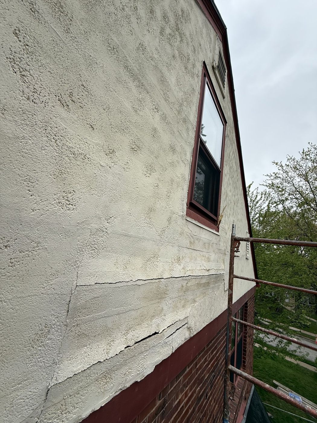 Cracked stucco wall prepared for repair at an Omaha-area home