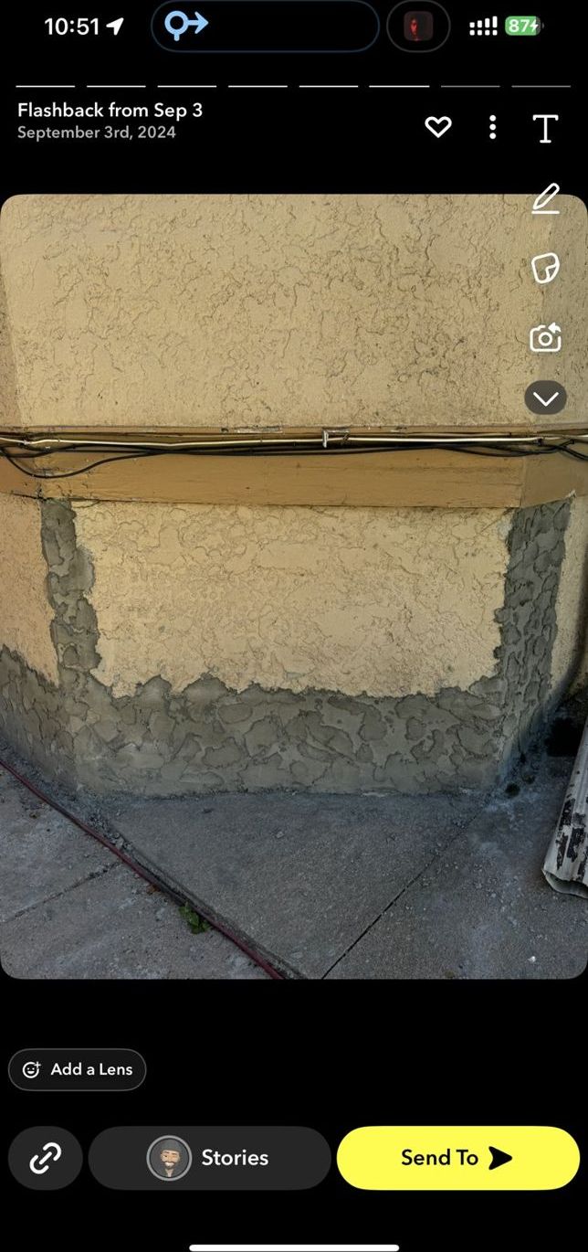 Stucco patch repair on a commercial wall base in the Omaha area